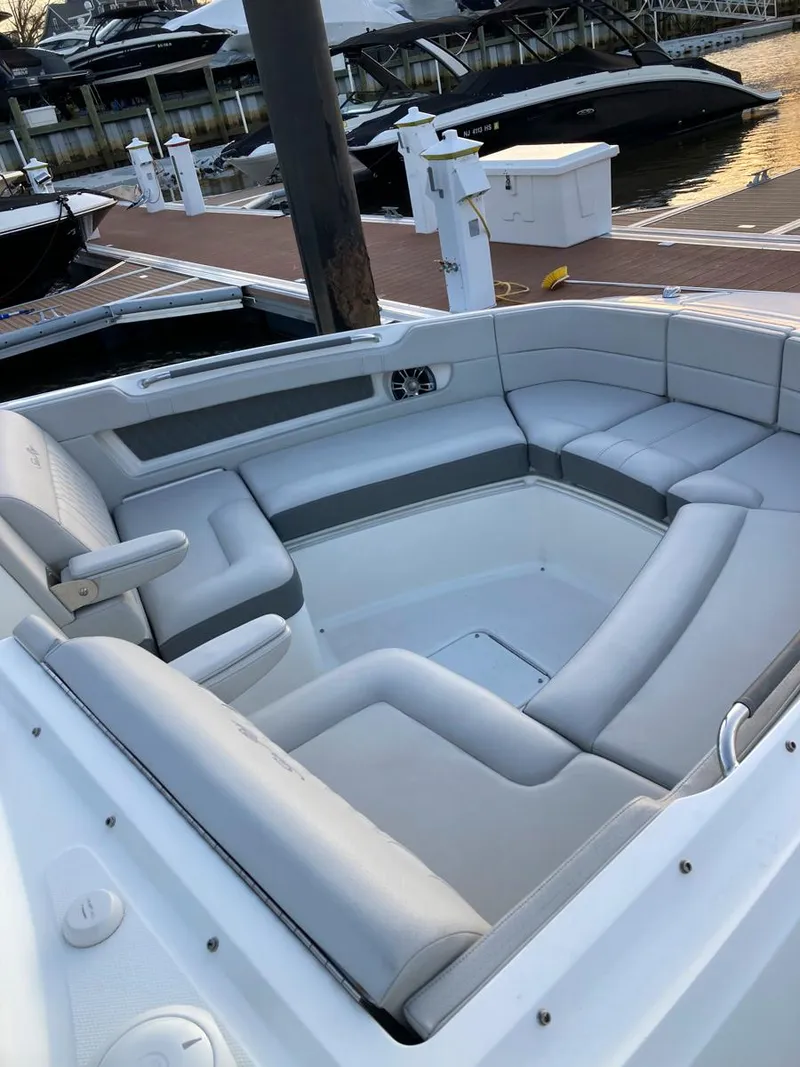 Slide: The Image of 2021 Sea Ray SLX 310 OB boat with spacious seating at a marina. - 31