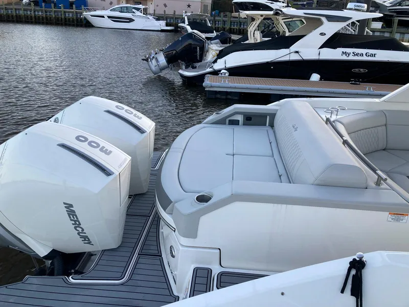 Slide: The Image of 2021 Sea Ray SLX 310 OB with twin Mercury outboards docked at marina. - 32