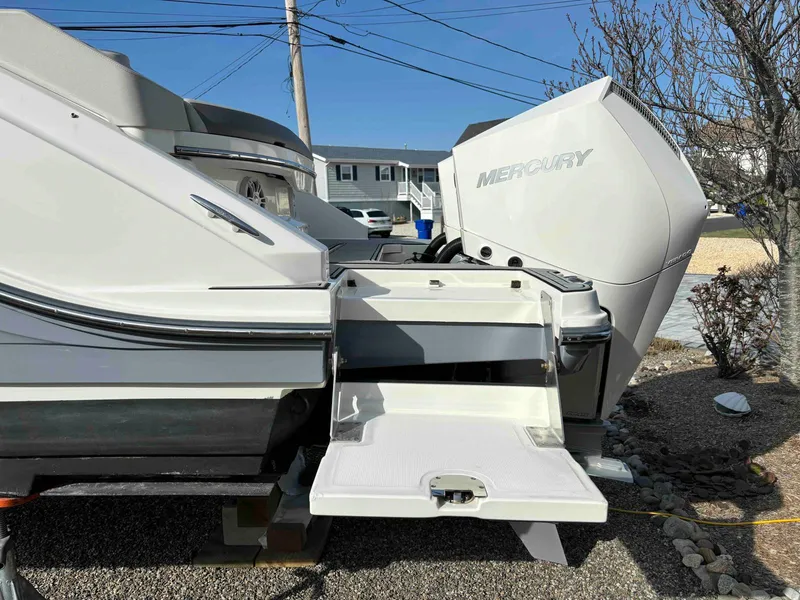 Slide: The Image of 2021 Sea Ray SLX 310 OB boat with Mercury outboard engine, docked on gravel. - 37