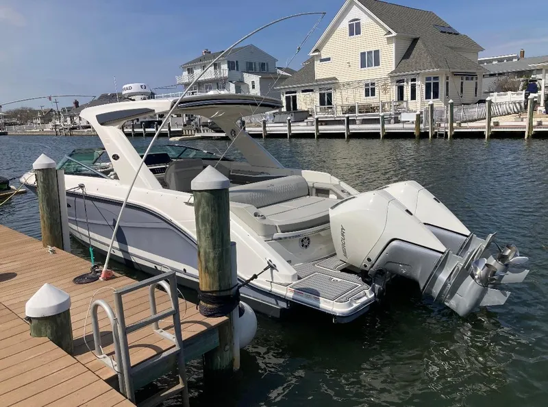 Slide: The Image of 2021 Sea Ray SLX 310 OB docked by waterfront homes. - 5