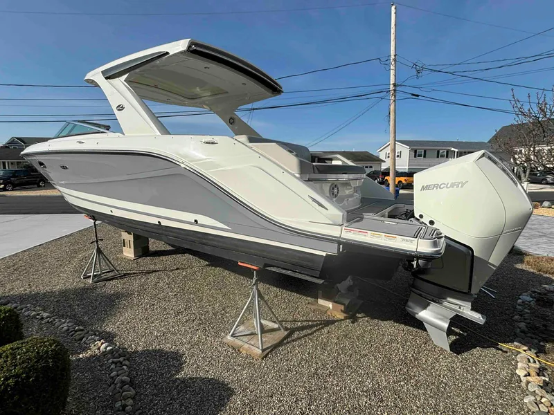 Slide: The Image of 2021 Sea Ray SLX 310 OB boat on display with Mercury outboard engine. - 6