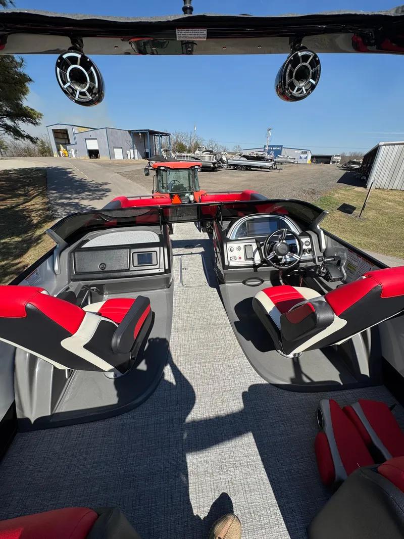 Slide: The Image of 2023 South Bay 25 Sport RS9 DC boat interior with red and black seating, modern dashboard. - 10