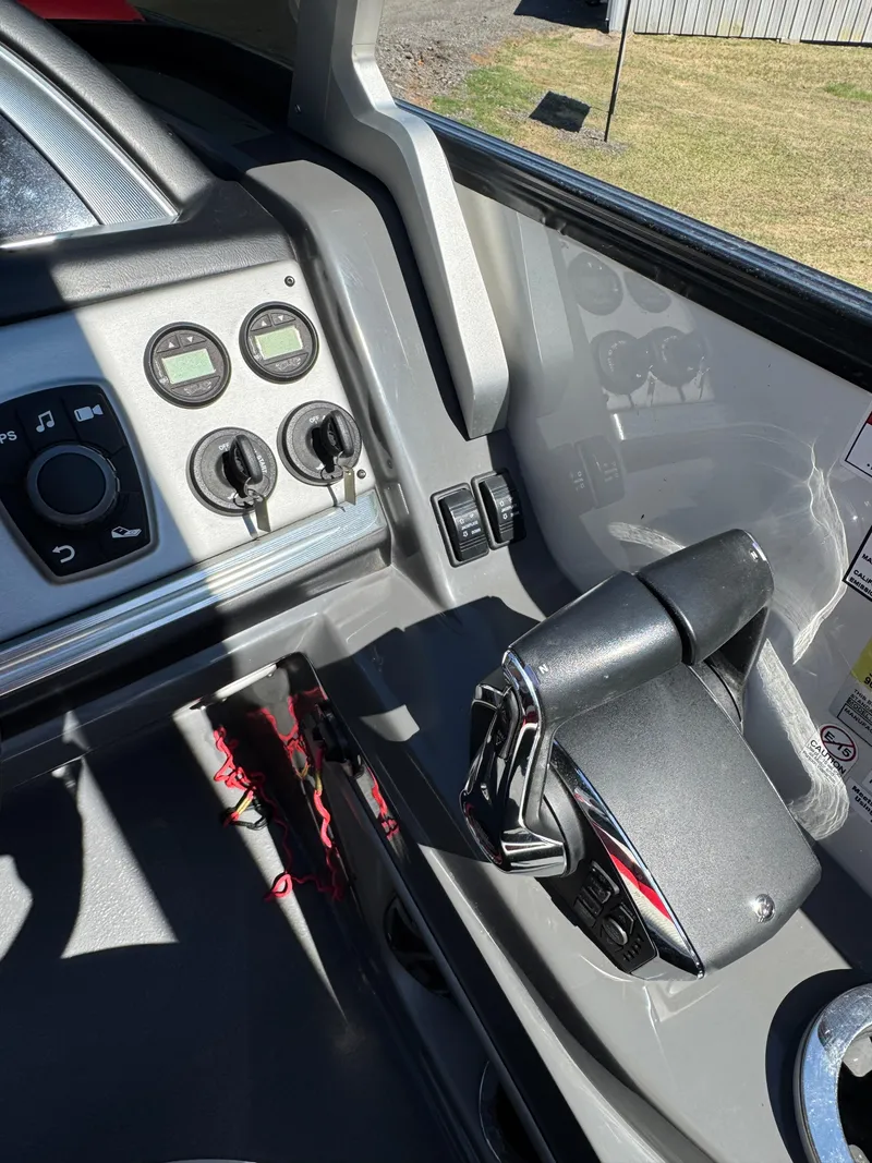 Slide: The Image of Control panel of 2023 South Bay 25 Sport RS9 DC boat, featuring gauges and throttle. - 13
