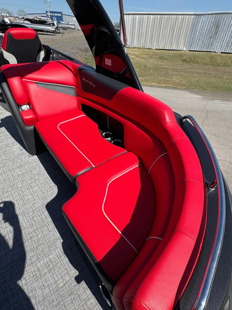 Slide: The Image of Red seating on 2023 South Bay 25 Sport RS9 DC boat, outdoor setting. - 17