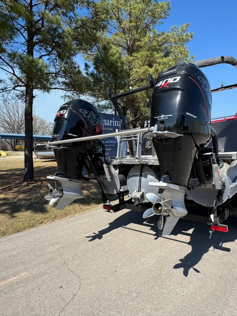 Slide: The Image of 2023 South Bay 25 Sport RS9 DC with dual outboard motors on a sunny day. - 3