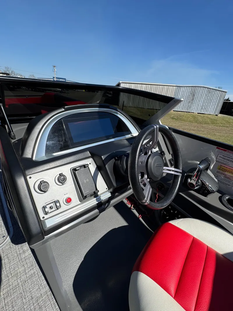 Slide: The Image of 2023 South Bay 25 Sport RS9 DC boat dashboard with steering wheel and controls. - 5