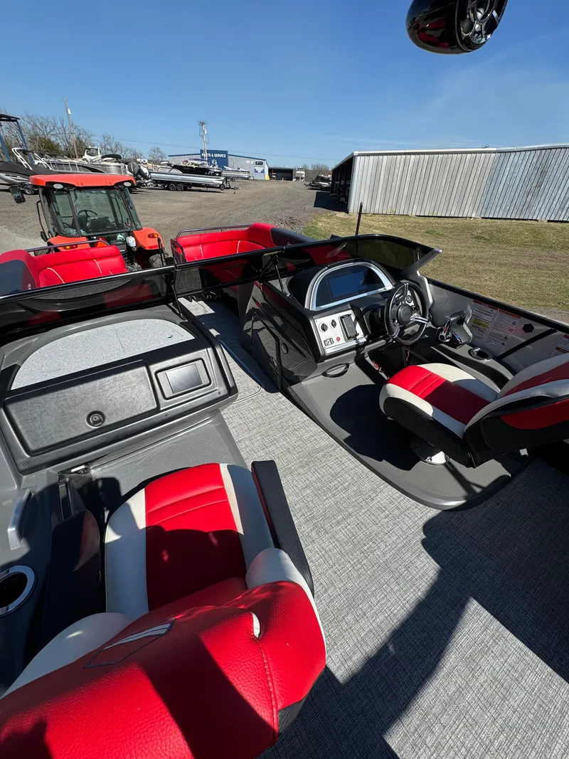 Slide: The Image of 2023 South Bay 25 Sport RS9 DC boat interior with red and gray seating. - 6