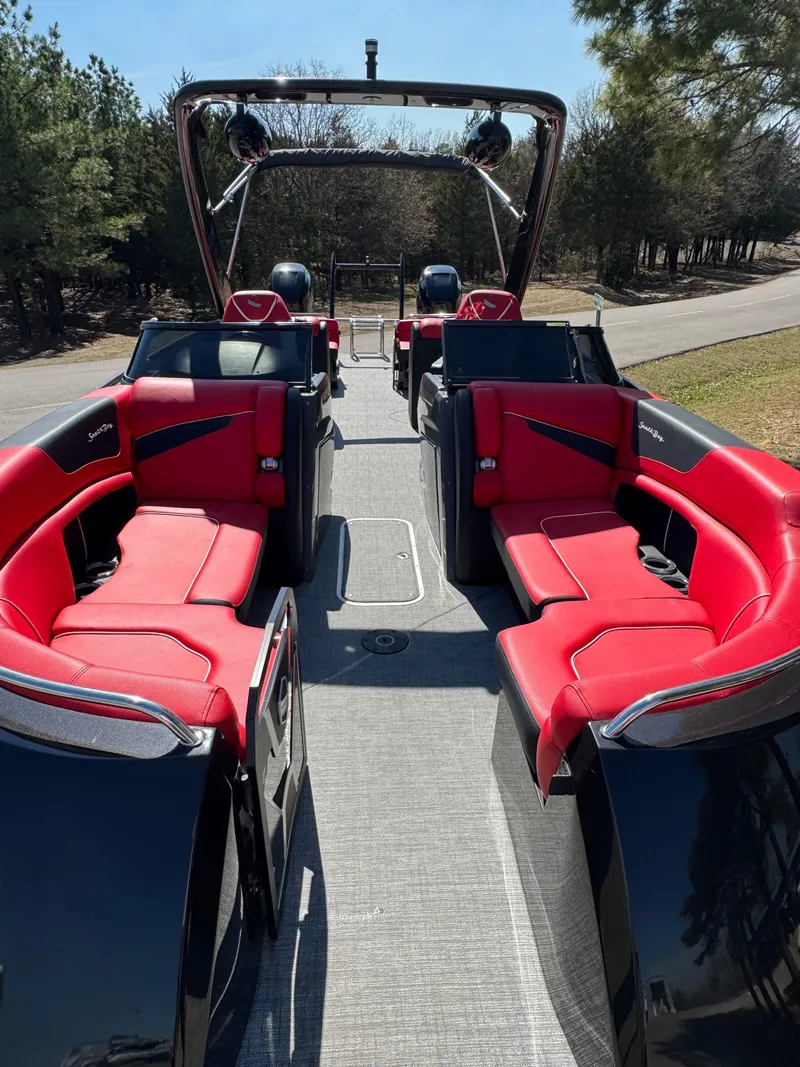 Slide: The Image of 2023 South Bay 25 Sport RS9 DC boat with red seating and sleek design. - 7