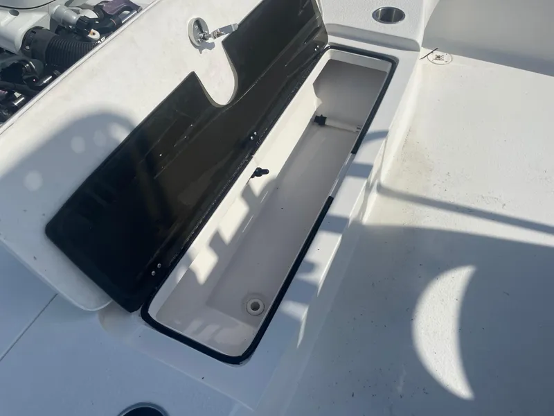 Slide: The Image of Open storage compartment on a 2022 Catalyst 2550 CAT boat deck. - 10