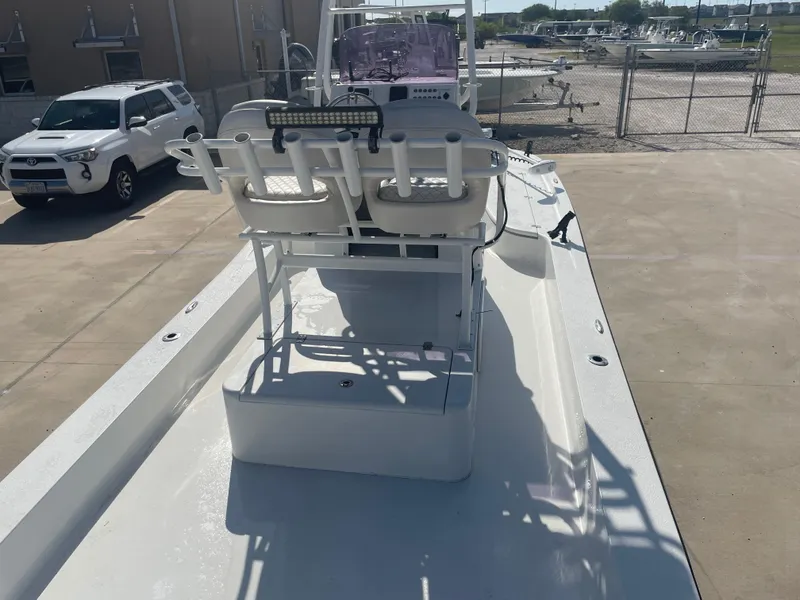 Slide: The Image of 2022 Catalyst 2550 CAT boat with dual seats, parked near a white SUV. - 12