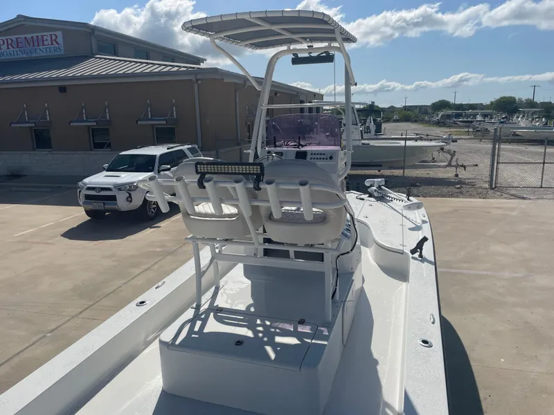 Slide: The Image of 2022 Catalyst 2550 CAT boat in a marina parking lot under a clear sky. - 14
