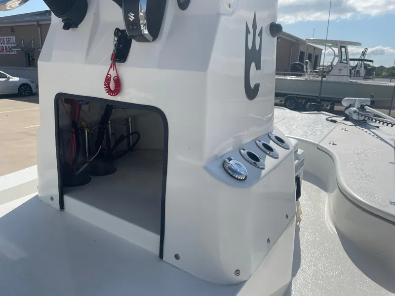 Slide: The Image of 2022 Catalyst 2550 CAT boat console with storage compartment and control panel. - 15