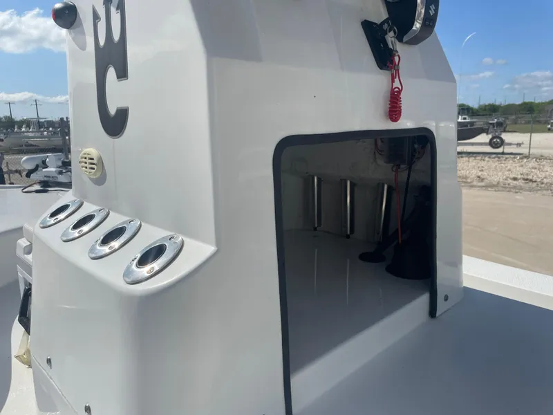 Slide: The Image of 2022 Catalyst 2550 CAT boat console with rod holders and storage compartment. - 16