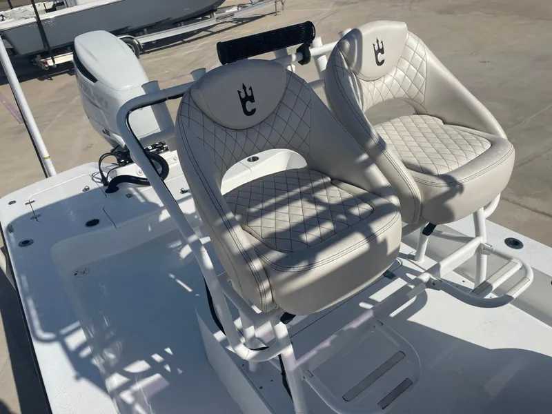 Slide: The Image of Luxury seating on 2022 Catalyst 2550 CAT boat, featuring quilted design and modern outboard motor. - 18