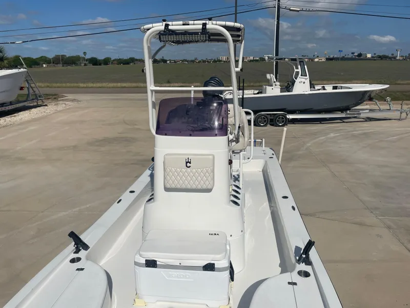 Slide: The Image of 2022 Catalyst 2550 CAT boat on a trailer, parked outdoors under a clear sky. - 20