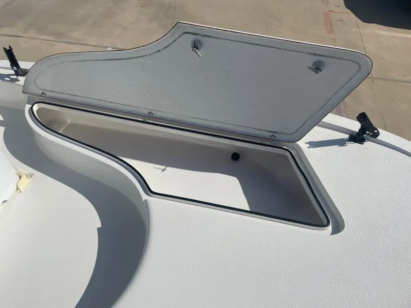 Slide: The Image of Open storage compartment on 2022 Catalyst 2550 CAT boat deck. - 22