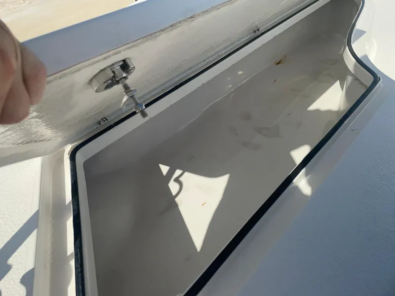 Slide: The Image of Open storage compartment on 2022 Catalyst 2550 CAT boat, showing interior details. - 23