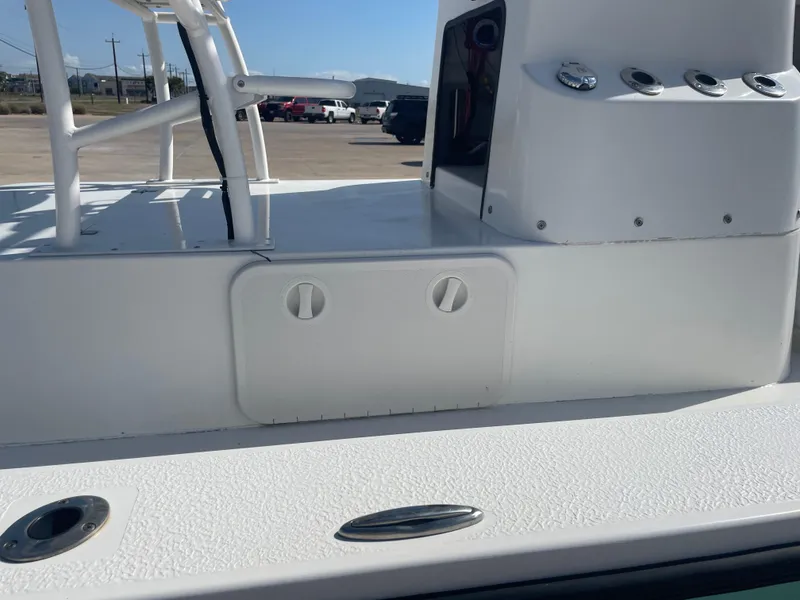 Slide: The Image of 2022 Catalyst 2550 CAT boat deck with storage compartment and rod holders. - 25