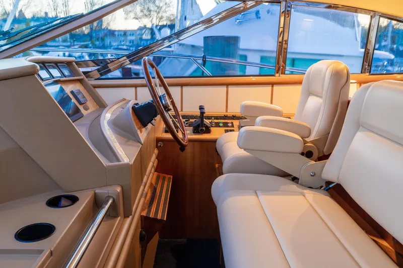 Slide: The Image of Luxurious helm of 2000 Neptunus 54 Express yacht with leather seats and wooden steering wheel. - 12
