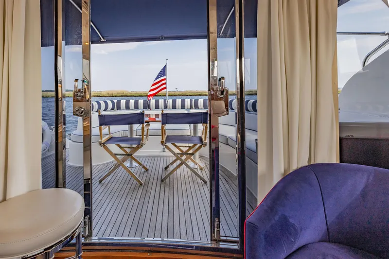 Slide: The Image of Interior view of 2000 Neptunus 54 Express yacht with deck chairs and American flag. - 19