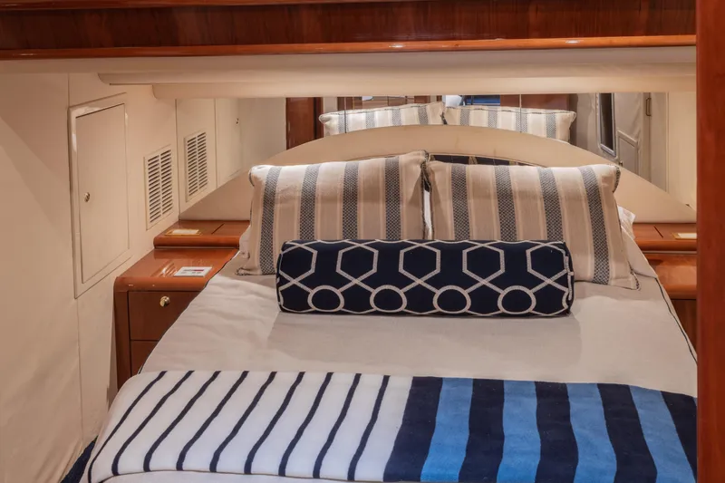 Slide: The Image of Luxurious cabin interior of 2000 Neptunus 54 Express yacht with striped bedding. - 28