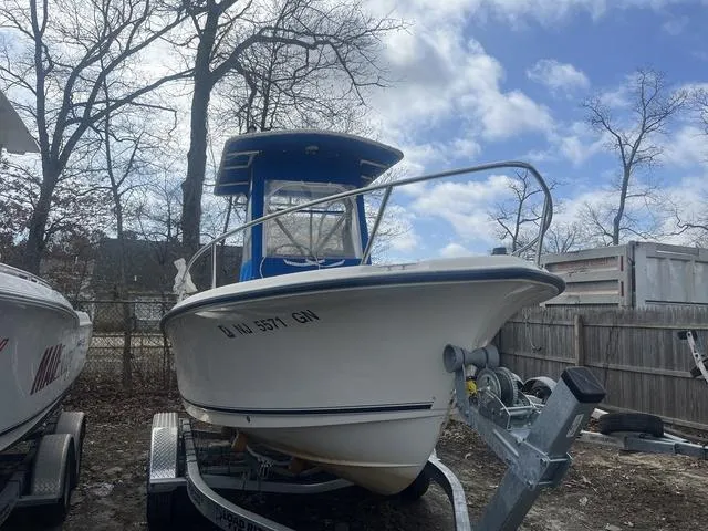 Slide: The Image of 2002 Sea Hunt 202 TRITON boat on trailer, parked outdoors under cloudy sky. - 2