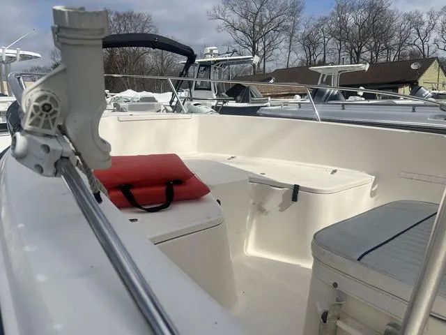 Slide: The Image of 2002 Sea Hunt 202 TRITON boat interior with seating and storage, docked outdoors. - 9