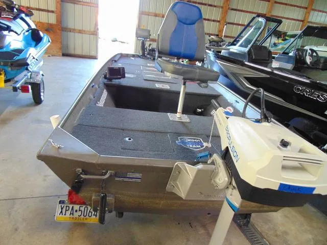 Slide: The Image of 2016 WeldBilt 1647 boat with blue seat and motor in a storage facility. - 4
