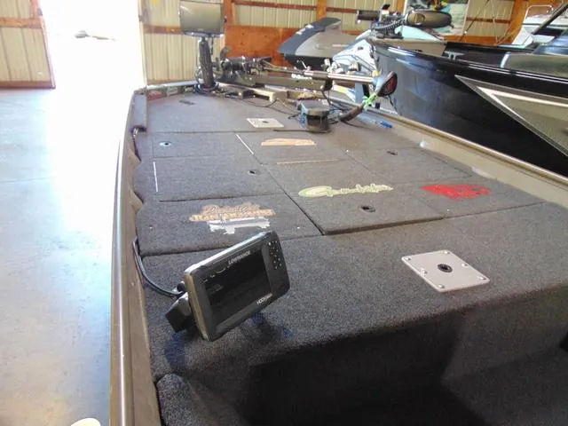 Slide: The Image of 2016 WeldBilt 1647 boat interior with fishing equipment and electronic display. - 5