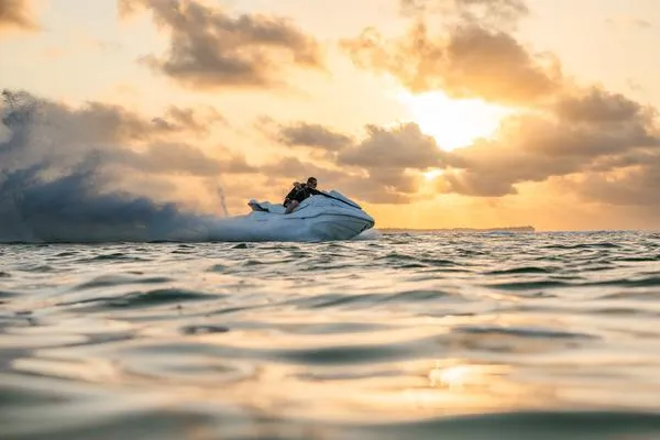 Slide: The Image of 2025 Yamaha Waverunner FX Cruiser SVHO gliding on water at sunset. - 10