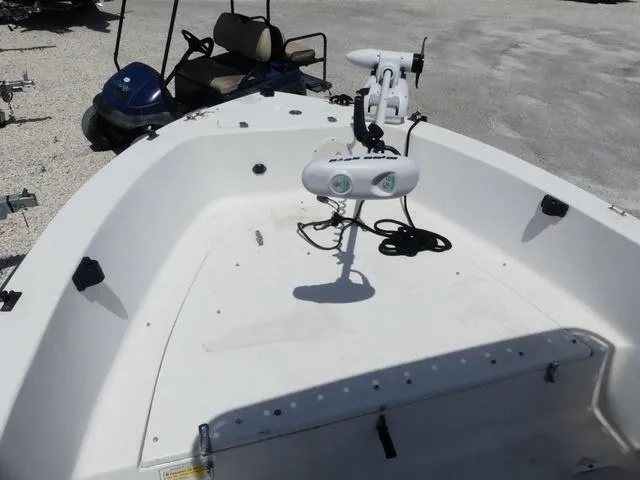 Slide: The Image of 2009 Angler 180 CC boat deck with mounted equipment, parked on gravel. - 11
