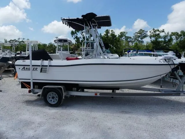 Slide: The Image of 2009 Angler 180 CC boat on trailer, parked outdoors under a clear sky. - 4