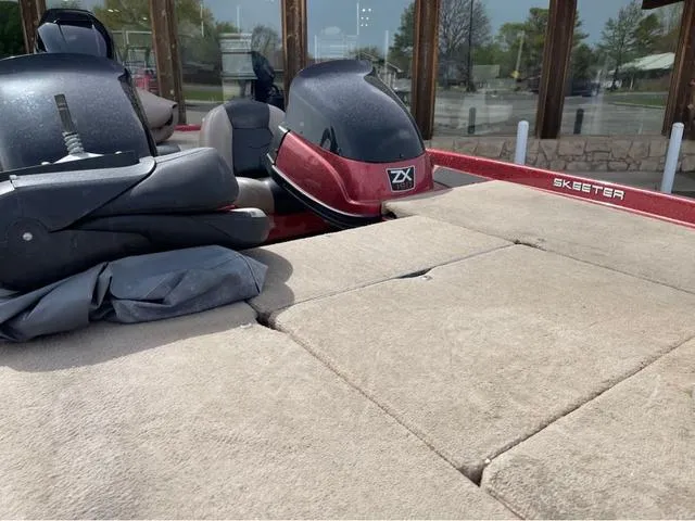 Slide: The Image of 2008 Skeeter ZX190 boat with cushioned deck and motor, parked outdoors. - 10