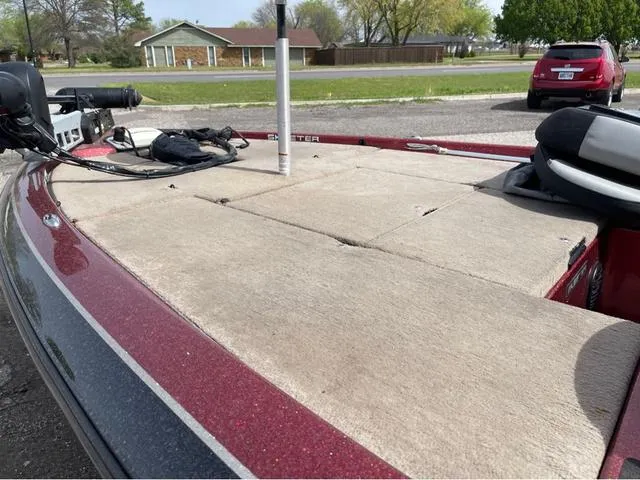 Slide: The Image of 2008 Skeeter ZX190 boat deck with red trim, parked outdoors. - 12