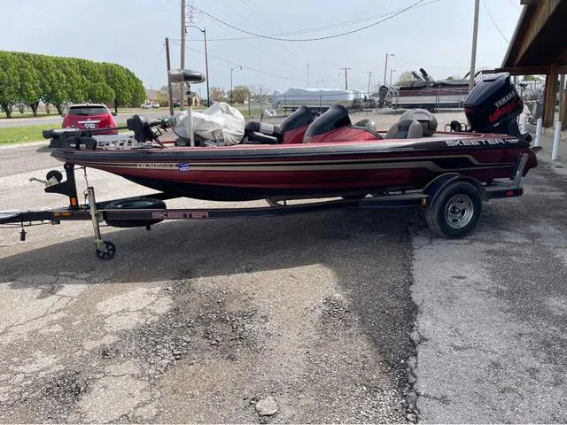 Slide: The Image of 2008 Skeeter ZX190 boat on trailer, parked outdoors, featuring Yamaha outboard motor. - 2