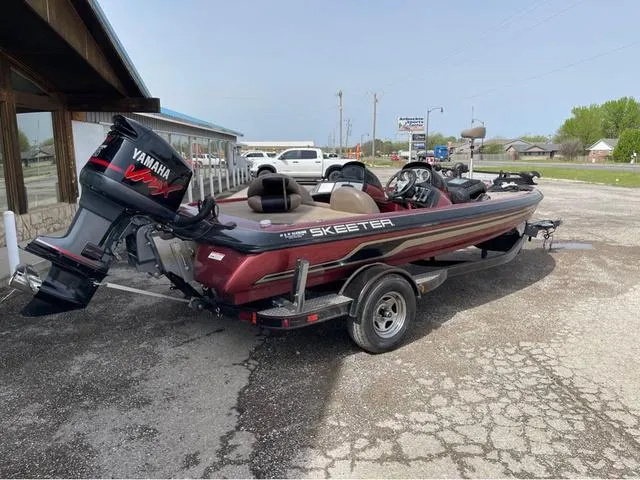 Slide: The Image of 2008 Skeeter ZX190 boat with Yamaha engine on a trailer, parked outdoors. - 4