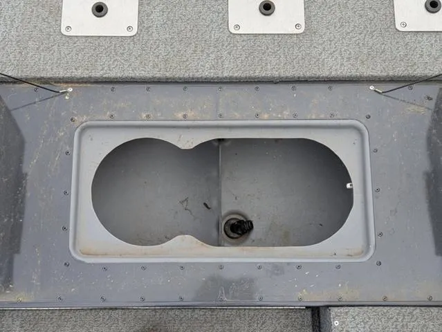 Slide: The Image of 2022 G3 Sportsman 1710 boat storage compartment, open and empty, with gray interior. - 33