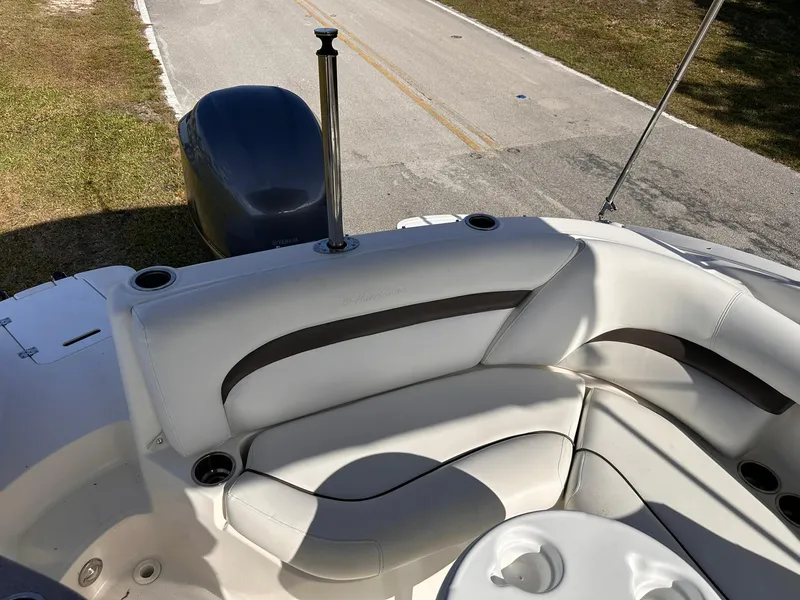 Slide: The Image of 2012 Hurricane SD2400 OB boat interior with white seating and cup holders. - 10