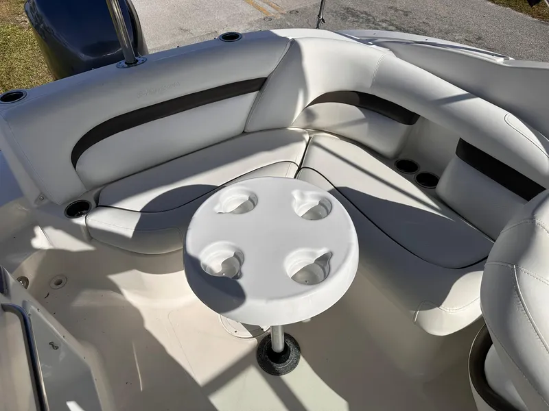 Slide: The Image of 2012 Hurricane SD2400 OB boat interior with white seating and round table. - 12