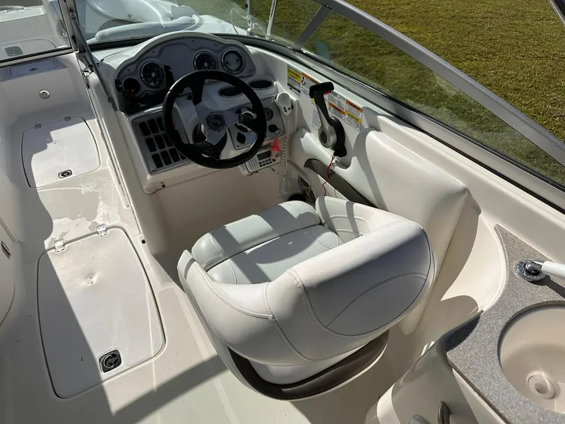 Slide: The Image of 2012 Hurricane SD2400 OB boat cockpit with steering wheel and white captain's chair. - 15