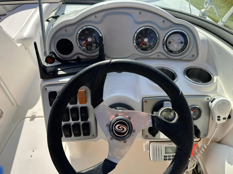 Slide: The Image of Steering wheel and dashboard of 2012 Hurricane SD2400 OB boat, featuring gauges and controls. - 16