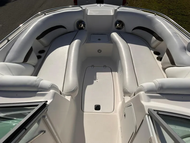 Slide: The Image of 2012 Hurricane SD2400 OB boat interior with white seating and storage compartments. - 17