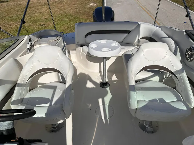 Slide: The Image of 2012 Hurricane SD2400 OB boat interior with white seating and round table. - 21