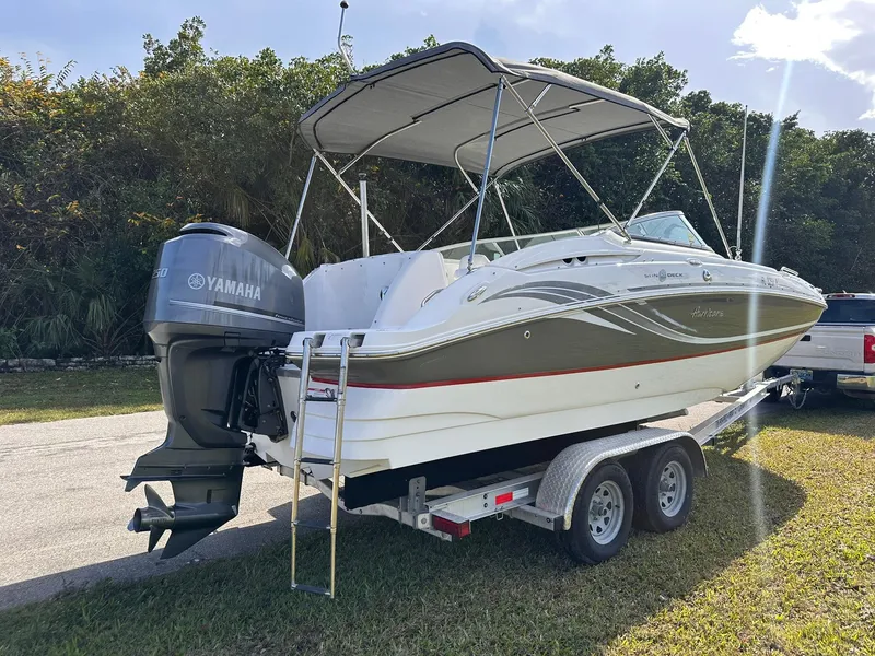 Slide: The Image of 2012 Hurricane SD2400 OB boat on trailer with Yamaha outboard motor, parked outdoors. - 3