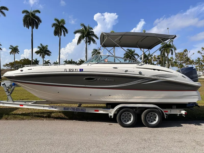 Slide: The Image of 2012 Hurricane SD2400 OB boat on trailer, palm trees in background, sunny day. - 6