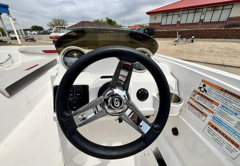 Slide: The Image of Steering wheel of 2022 Hurricane SunDeck Sport 185 OB boat, featuring dashboard controls. - 4