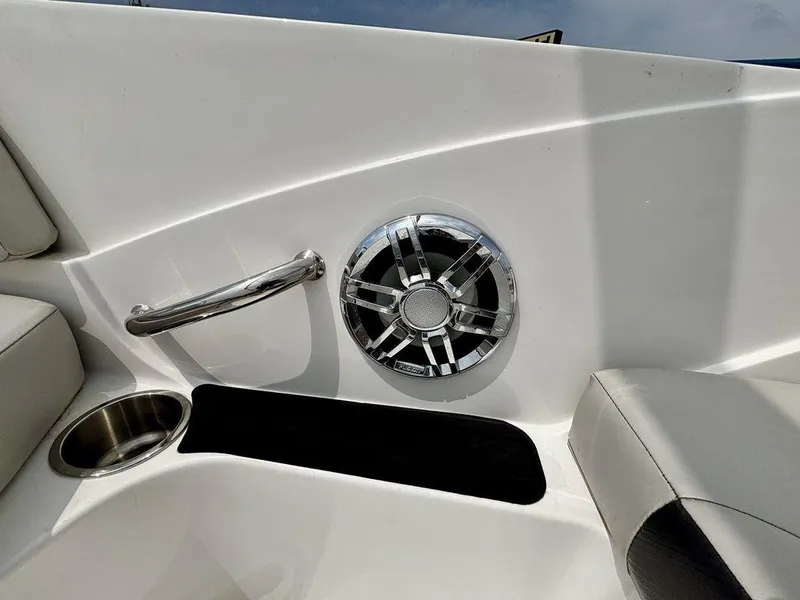 Slide: The Image of 2022 Hurricane SunDeck Sport 185 OB interior with speaker, cup holder, and handle. - 8