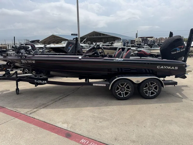 Slide: The Image of 2021 Caymas CX 20 boat on trailer, parked outdoors at a dealership. - 1