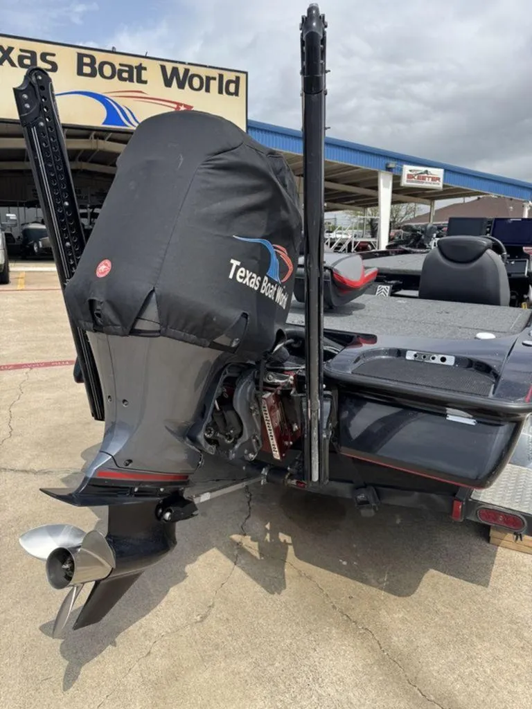 Slide: The Image of 2021 Caymas CX 20 boat at Texas Boat World dealership, rear view with covered motor. - 10