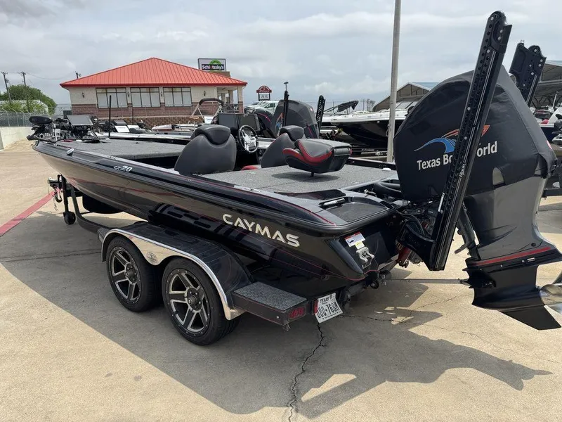 Slide: The Image of 2021 Caymas CX 20 boat on trailer at dealership, featuring sleek design and modern equipment. - 2